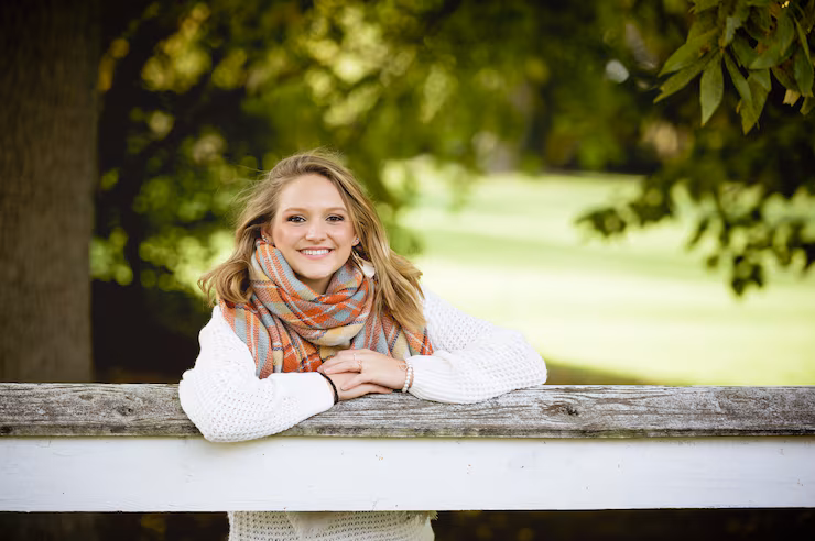 shallow-focus-shot-female-with-her-hands-fence-while-smiling-camera_181624-7163